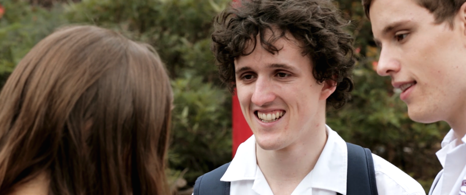 Still image from the film of main character Olly, in conversation