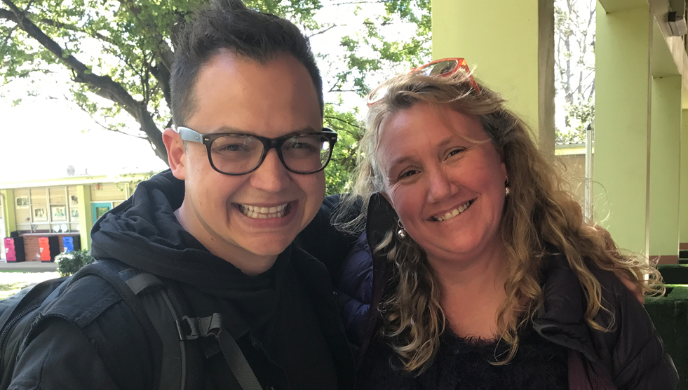 Sean Forbes, wearing black glasses, stand next to Riona Tindal, both smiling