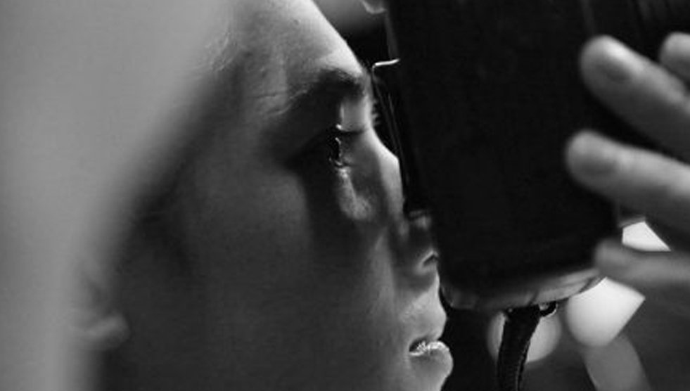 Createability: close up and side shot of a person looking through a camera