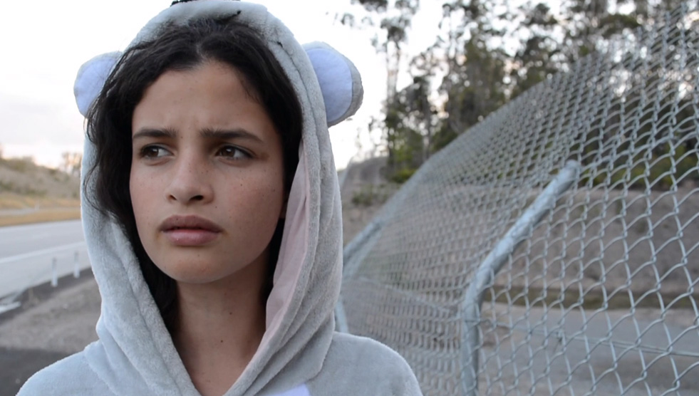 Artstate Bathurst: Close up of a young person wearing a hoodie with ears looking into the distance