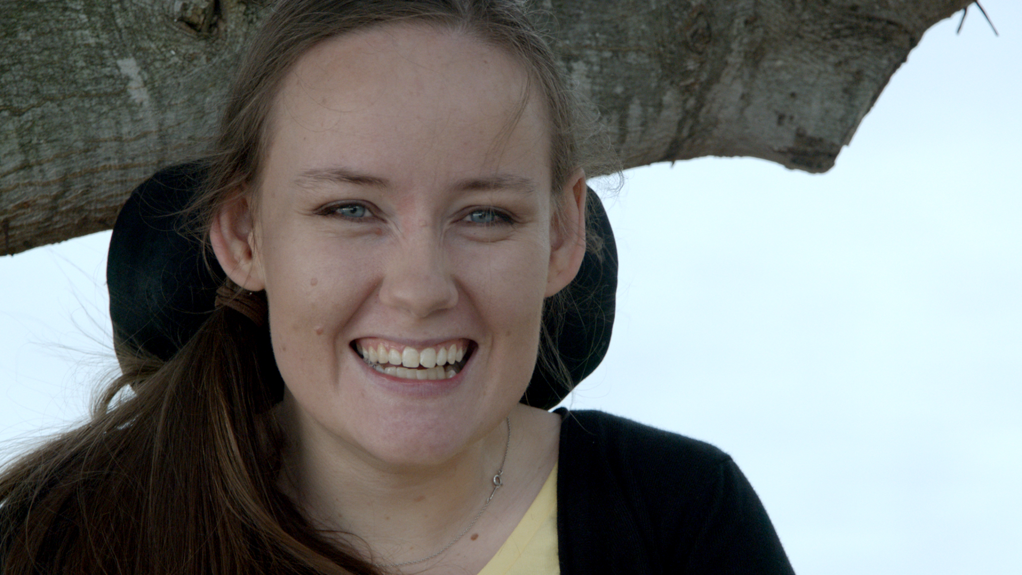 Image is a headshot of a smiling young woman - Emily Dash