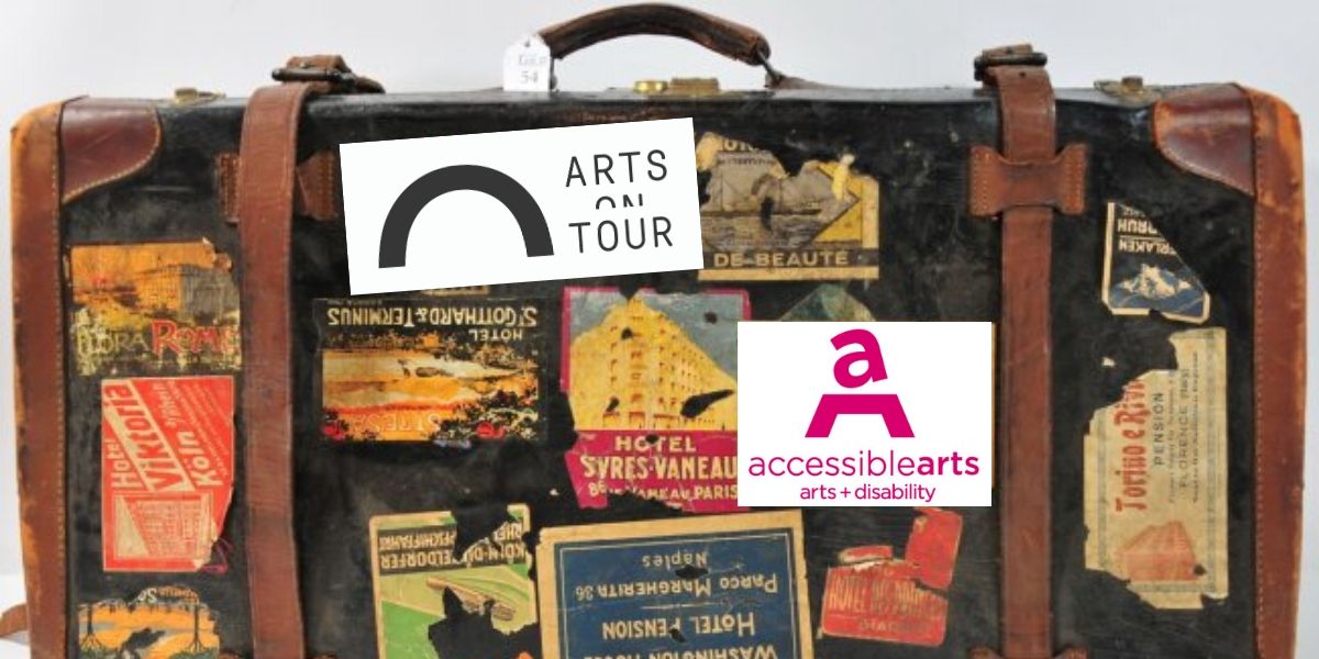 Vintage black and tan suitcase covered with old travel stickers